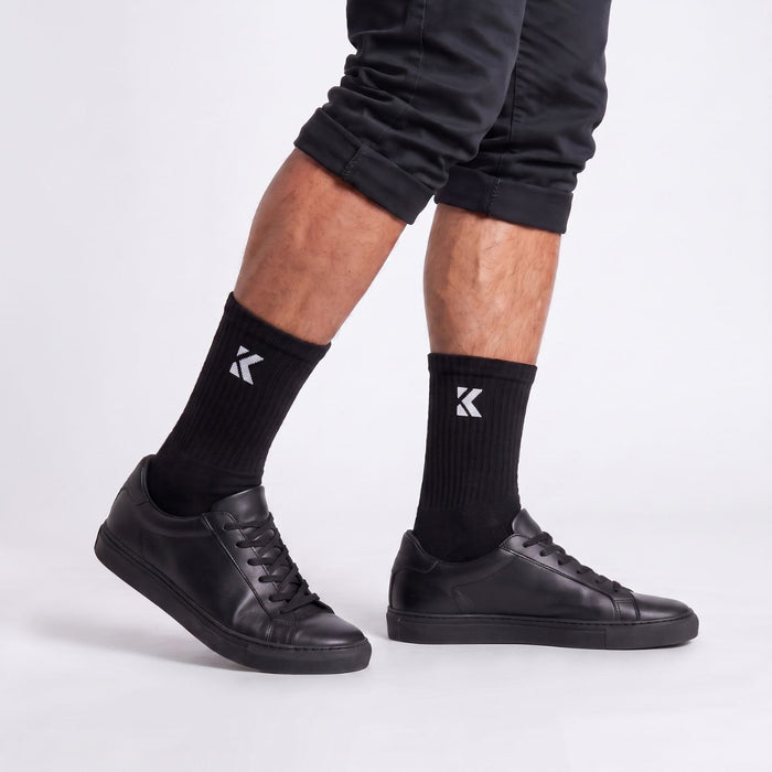 Model wearing black crew socks shown from the side, highlighting the crew length and comfortable fit.