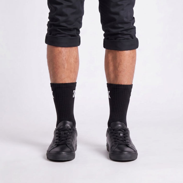 Model wearing black crew socks from the front, showcasing the classic fit and premium everyday style.