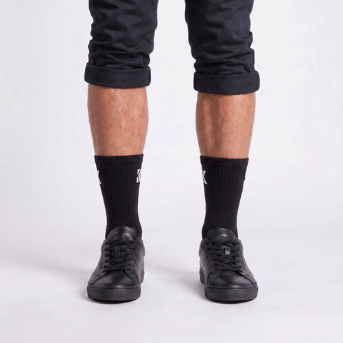 Model wearing black crew socks from the front, showcasing the classic fit and premium everyday style.