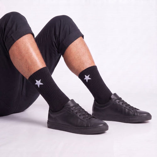 Model wearing Black Crew Socks with black sneakers, highlighting moisture-wicking crew socks with cushioned comfort for everyday wear.