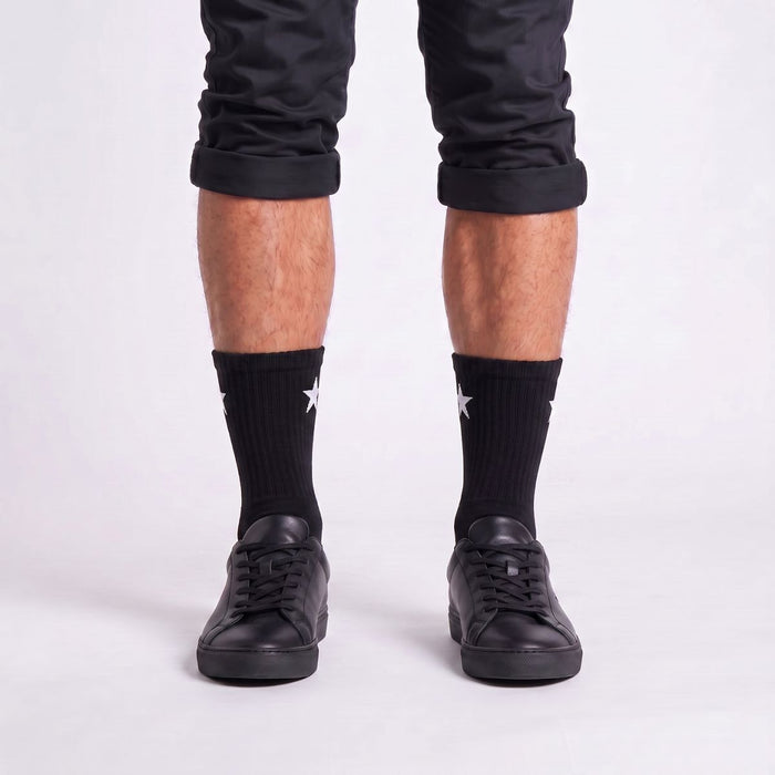 Model wearing Black Crew Socks with black sneakers, showcasing men's crew socks for athletic style.