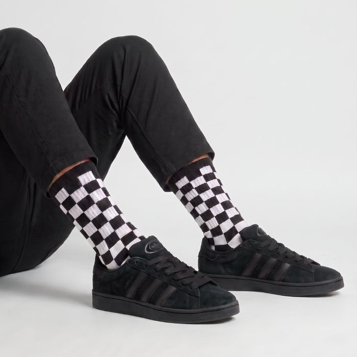 Model wearing Core Black White Adidas Campus 00s with Black 15mm wide replacement laces in a clean studio setting by Kicks Shoelaces