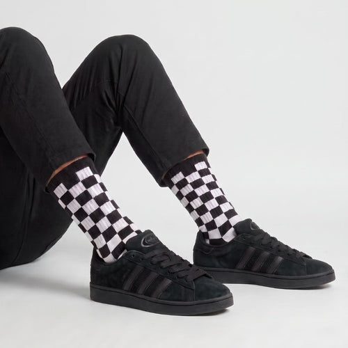 Model wearing Core Black White Adidas Campus 00s with Black 15mm wide replacement laces in a clean studio setting by Kicks Shoelaces