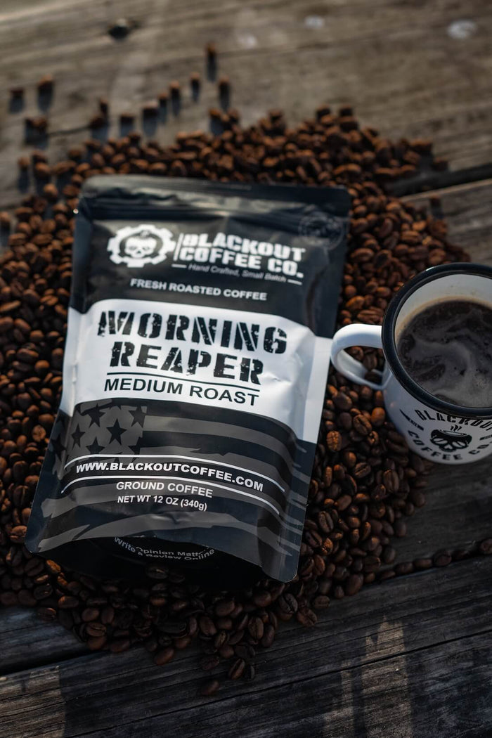 Blackout Coffee Co. Morning Reaper coffee package with a cup of coffee on coffee beans.