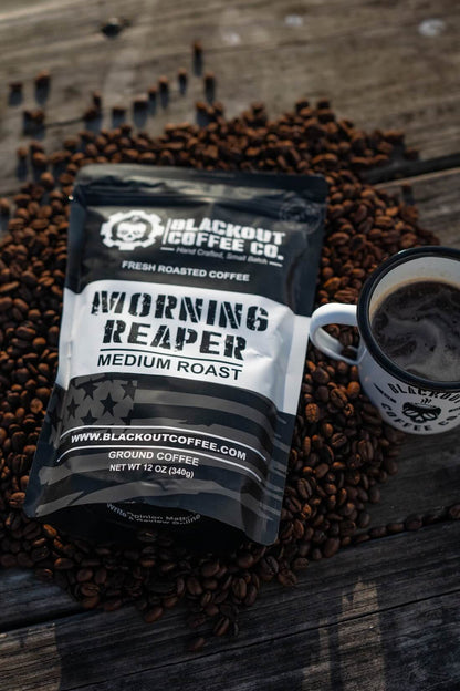 Blackout Coffee Co. Morning Reaper coffee package with a cup of coffee on coffee beans.