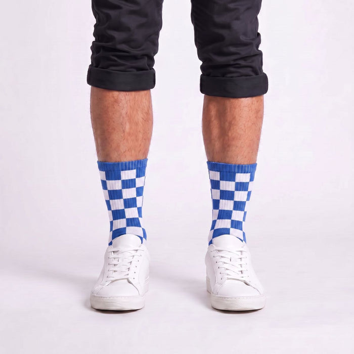 Model wearing blue and white checkered crew socks styled with sneakers