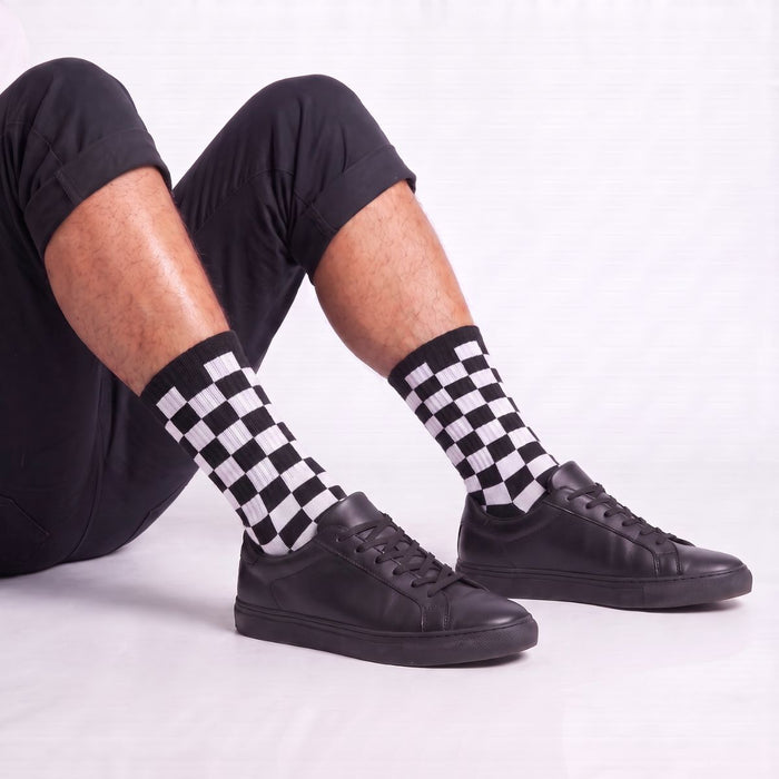 Model wearing black and white checkered crew socks styled with sneakers