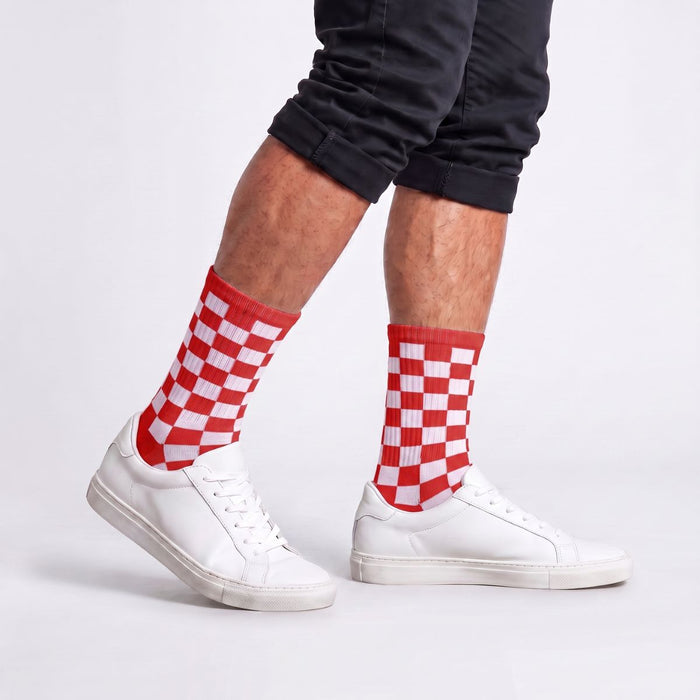 Model wearing red and white checkered crew socks with streetwear outfit