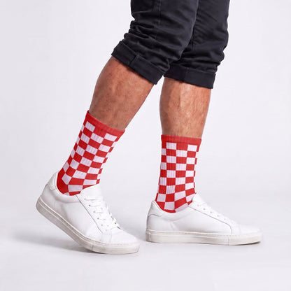 Model wearing red and white checkered crew socks with streetwear outfit