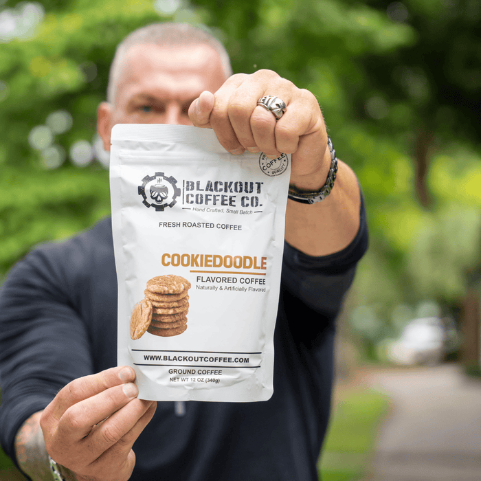 Cookiedoodle man holding the coffee bag
