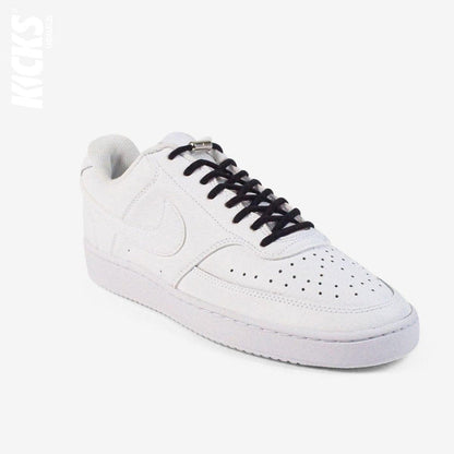 Black oval no-tie elastic shoelaces installed on white sneakers by Kicks Shoelaces