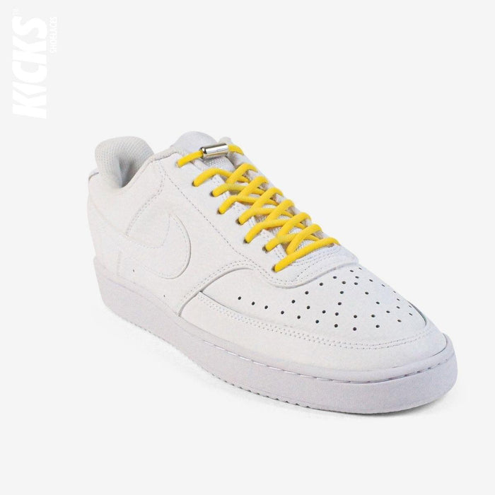 Golden yellow oval no-tie elastic shoelaces installed on white sneakers by Kicks Shoelaces