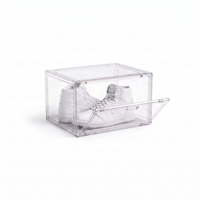 Clear shoe display box with magnetic drop-down door holding a pair of white high-top sneakers
