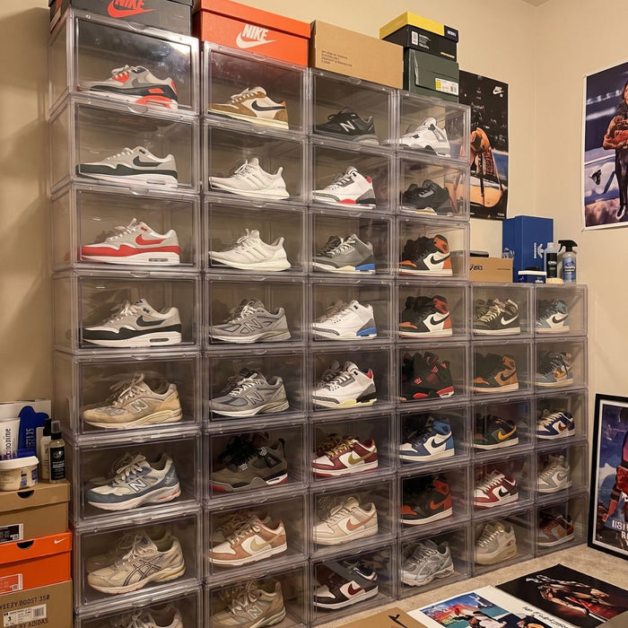 Large sneaker collection organised with stackable clear shoe boxes in a sneaker room