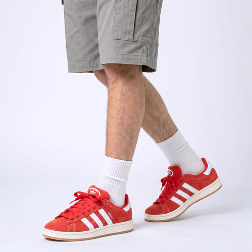 Model wearing Scarlet Red Adidas Campus 00s with Red 15mm wide replacement laces in a clean studio setting by Kicks Shoelaces