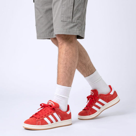 Model wearing Scarlet Red Adidas Campus 00s with Red 15mm wide replacement laces in a clean studio setting by Kicks Shoelaces