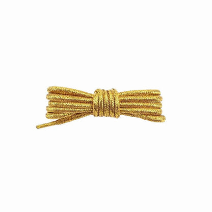 A pair of round, gold glitter shoelaces tied in a knot on a white background.