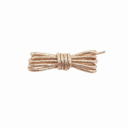 A pair of round, rose gold glitter shoelaces tied in a knot on a white background.