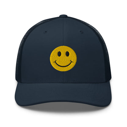 Navy smiley face embroidered trucker hat with adjustable mesh back, perfect for casual wear and streetwear style.