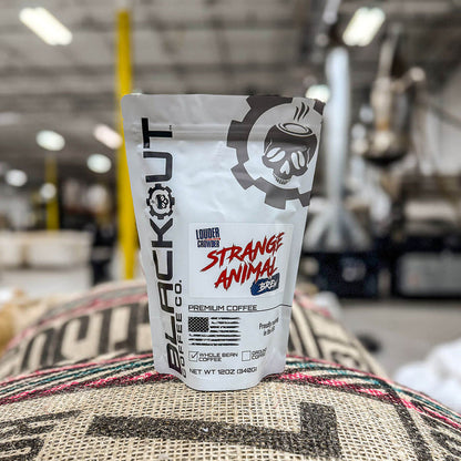Strange Animal coffee package on a burlap bag with a blurred warehouse background