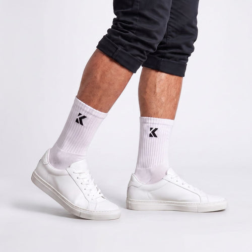 Model wearing white crew socks shown from the side, highlighting the crew length and comfortable fit.