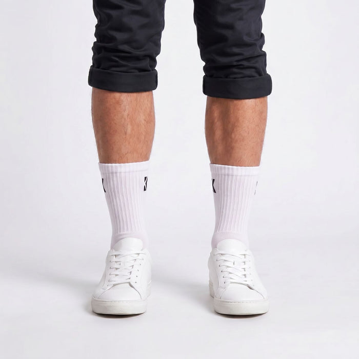 Model wearing white crew socks from the front, showcasing the classic fit and premium everyday style.